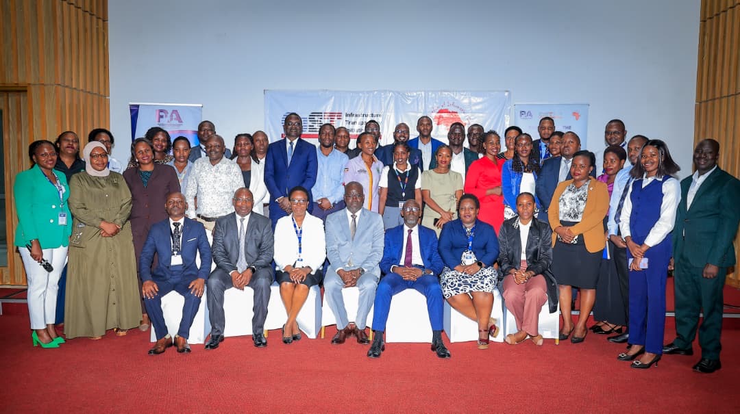 Group photograph of stakeholders at the GPP relaunch, seated and standing in front of an Infrastructure Transparency Initiative banner.